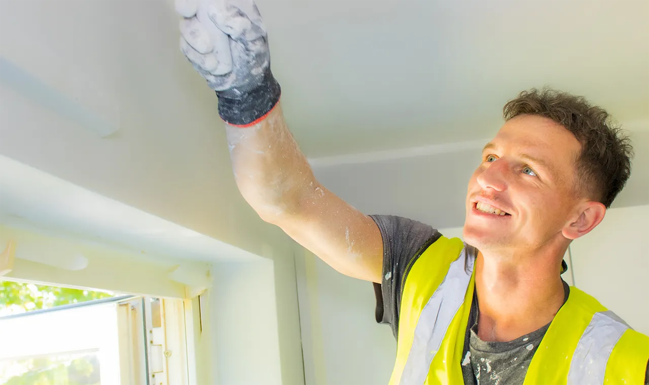 Apprentice Plastering Ceiling in Hi-Vis